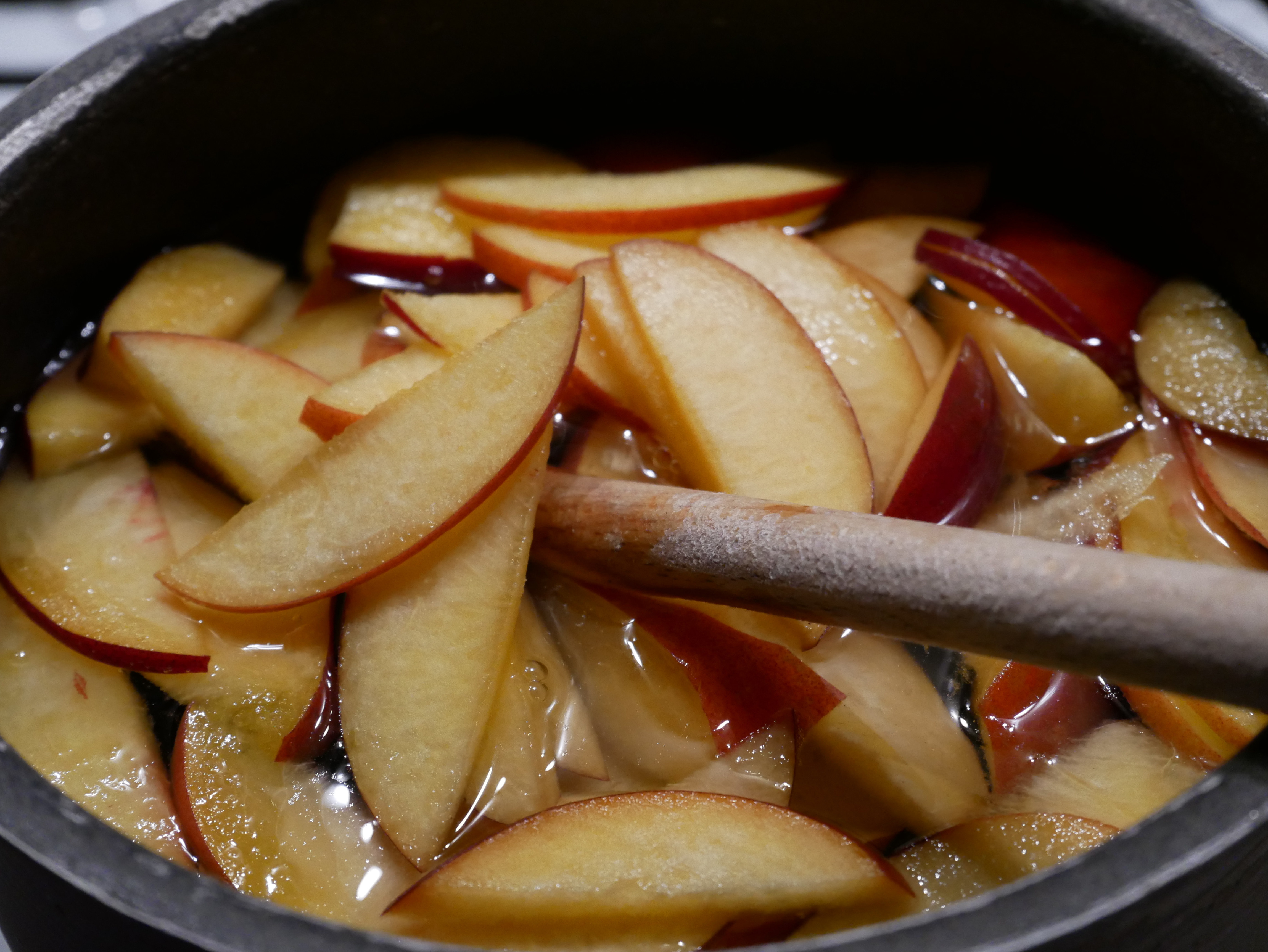 Des pêches cuisent dans du sirop